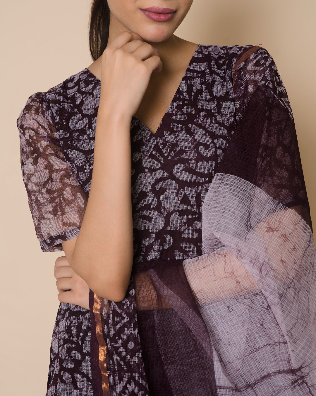 Detail of a dark print kurta with a sheer checked dupatta