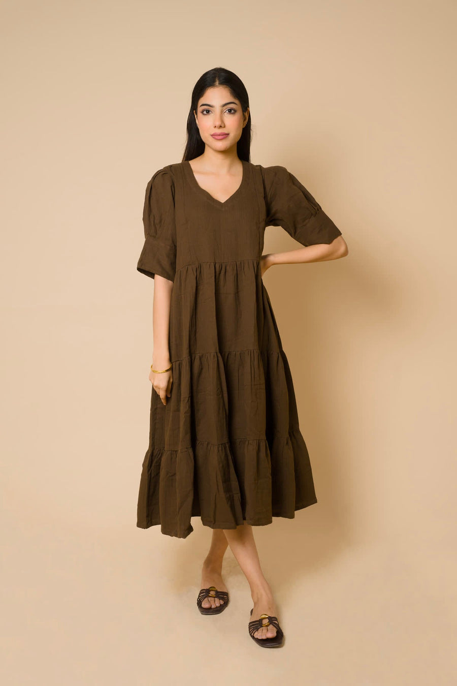 Woman in a brown tiered midi dress
