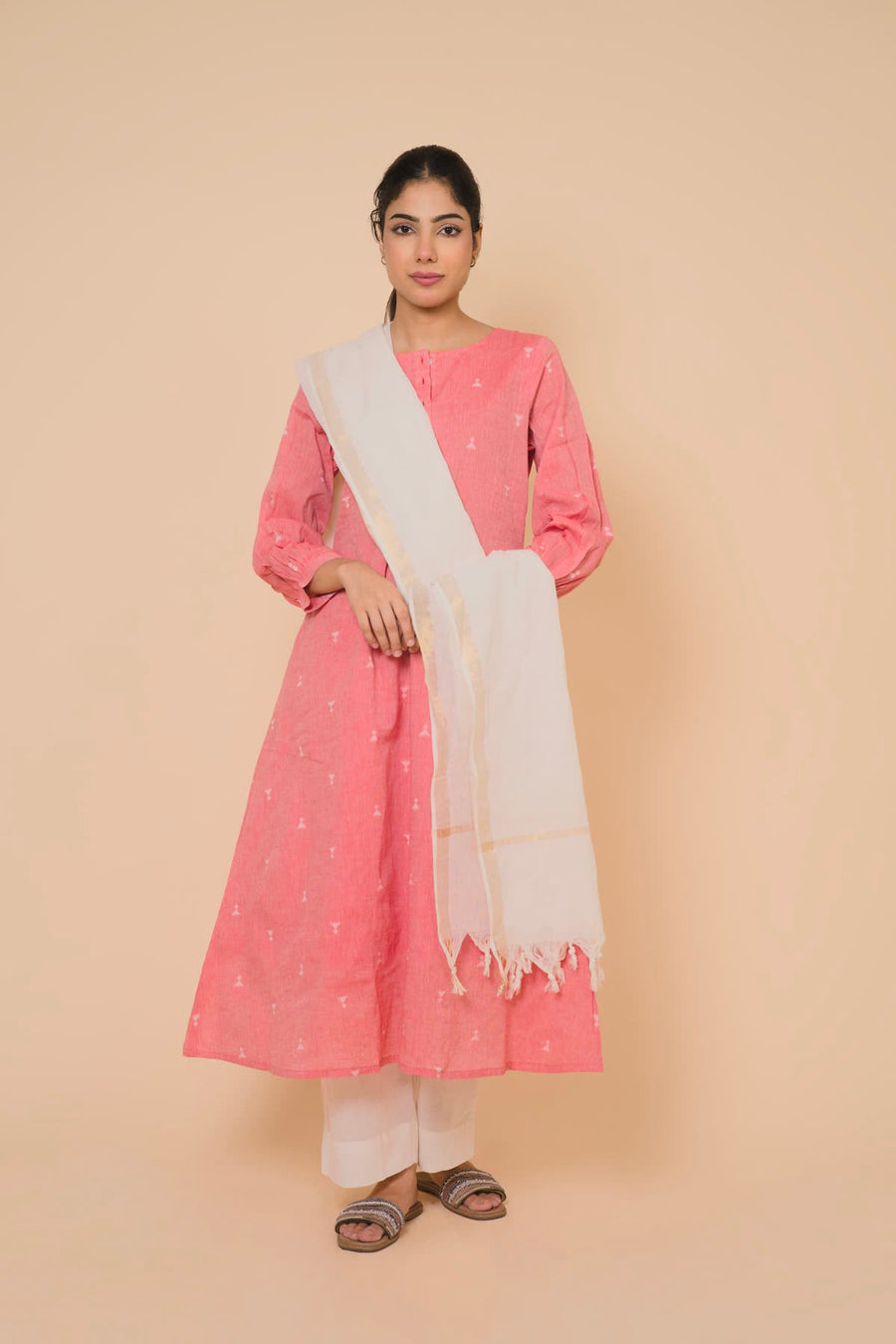 Woman in a pink kurta set with a cream dupatta