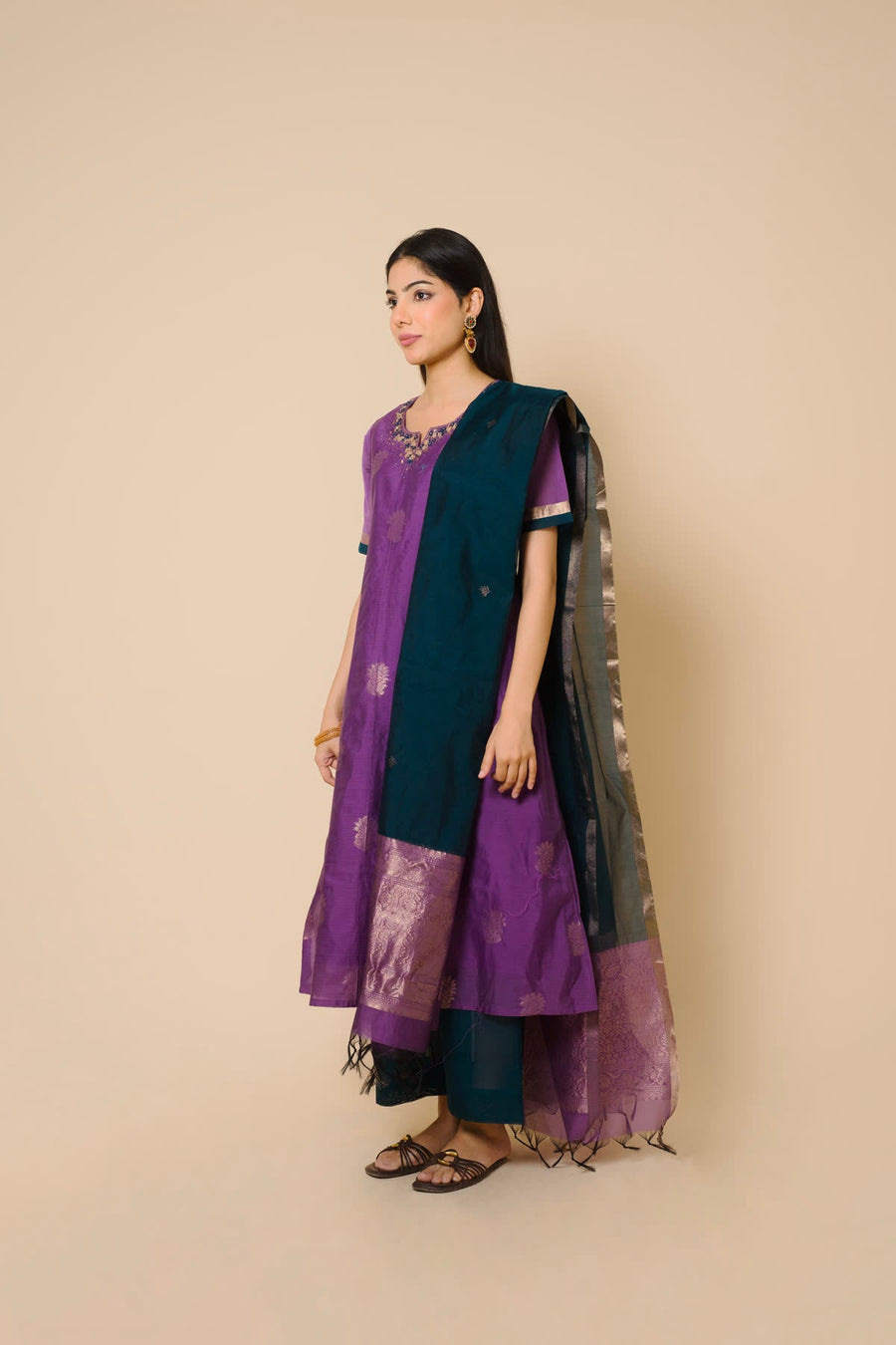 Woman in a purple kurta set with a green silk dupatta