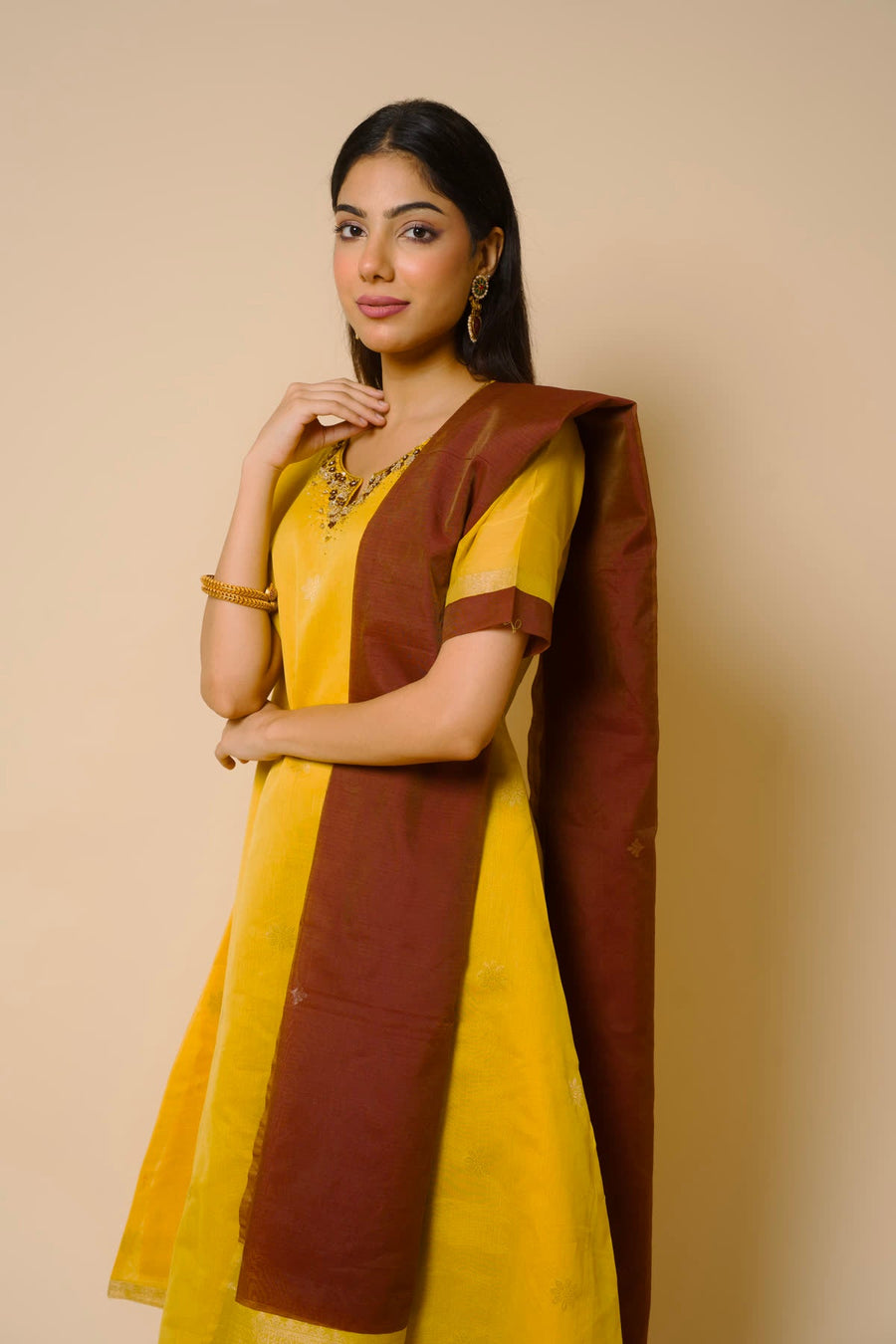 Woman in a mustard kurta with a brown dupatta