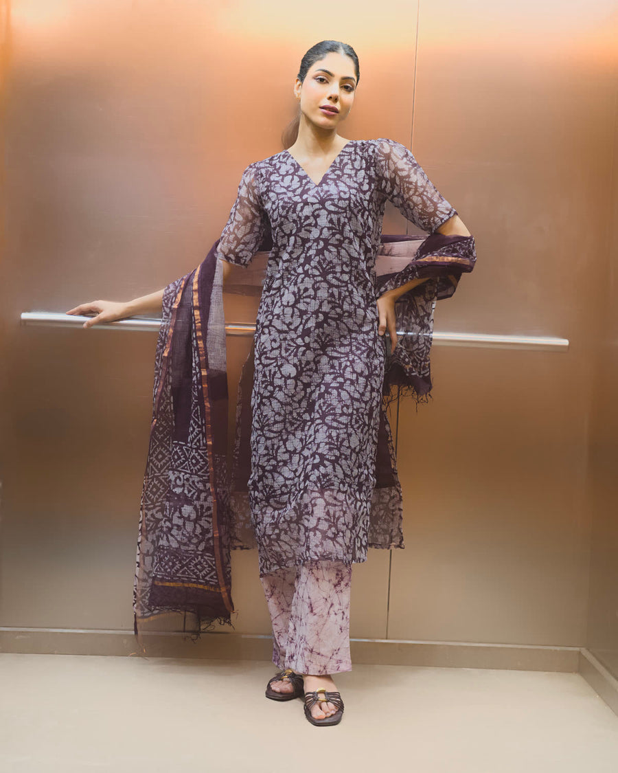 Woman in a printed kurta set with a dupatta in a lift