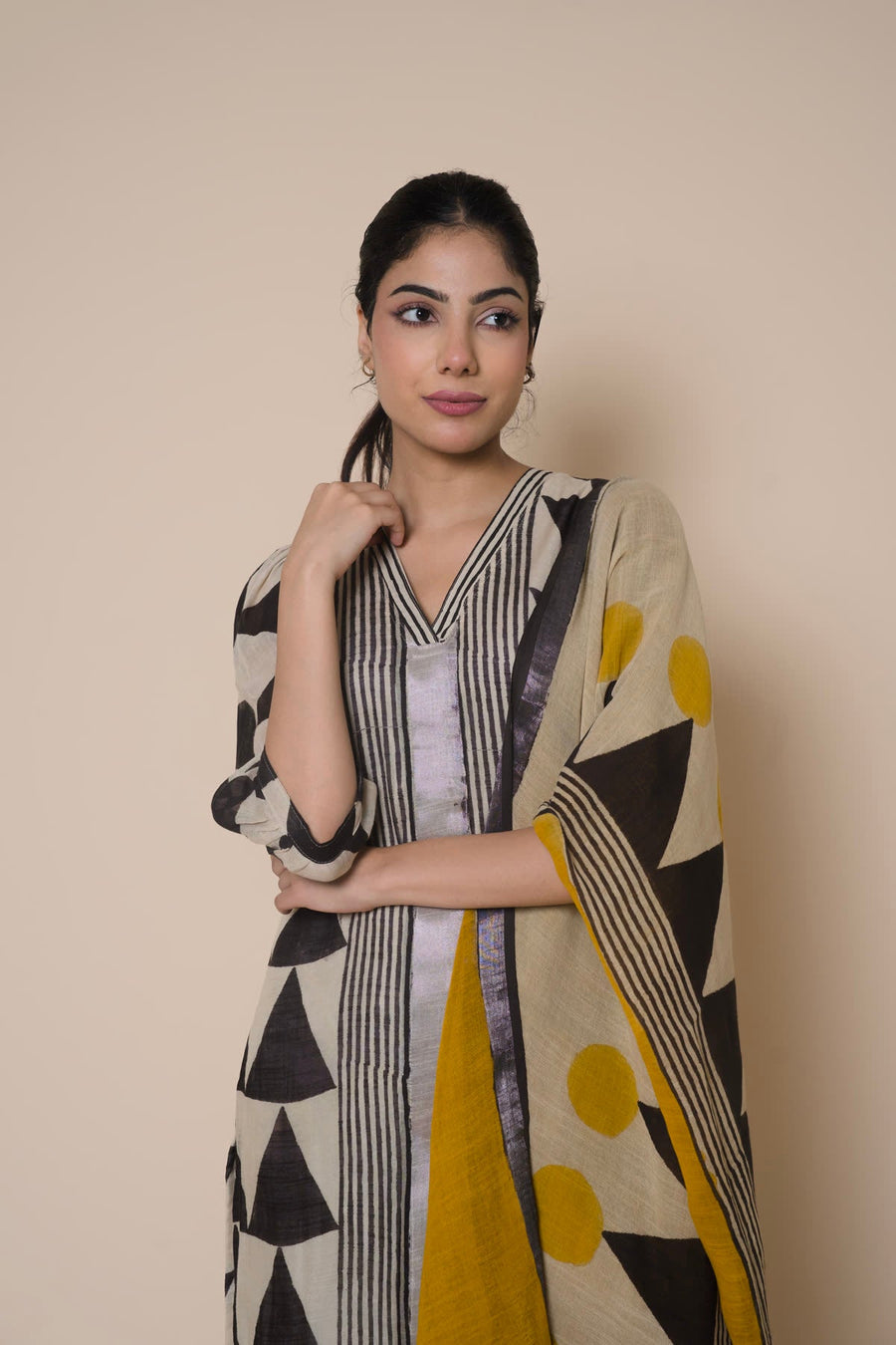 Woman in a triangle print kurta with a mustard dupatta