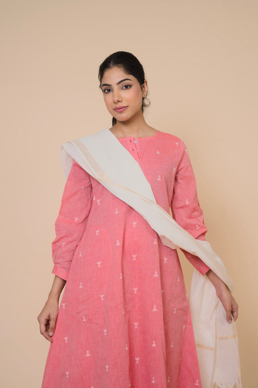 Woman in a pink kurta with a cream dupatta