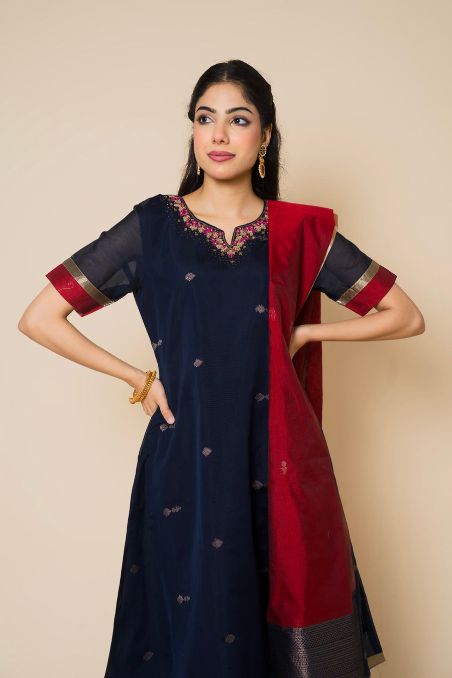 Woman in a navy kurta with a red dupatta